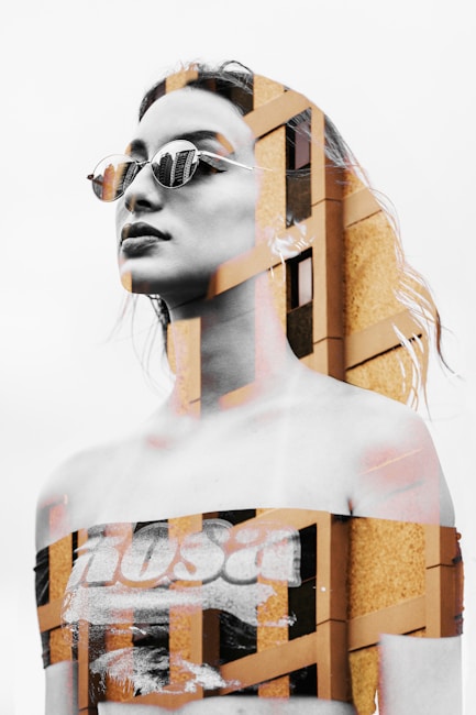 A black and white artistic overlay of a woman's portrait blended with architectural elements, such as building structures. The woman is wearing sunglasses and a tube top with text, capturing a modern and urban vibe.
