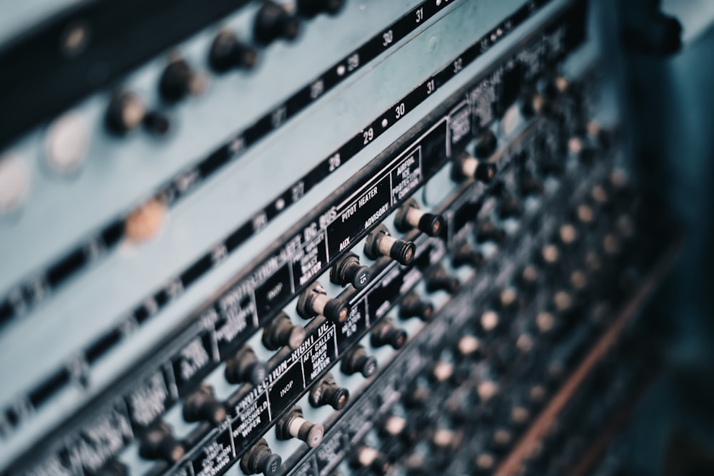 a close up of a sound board with many knobs