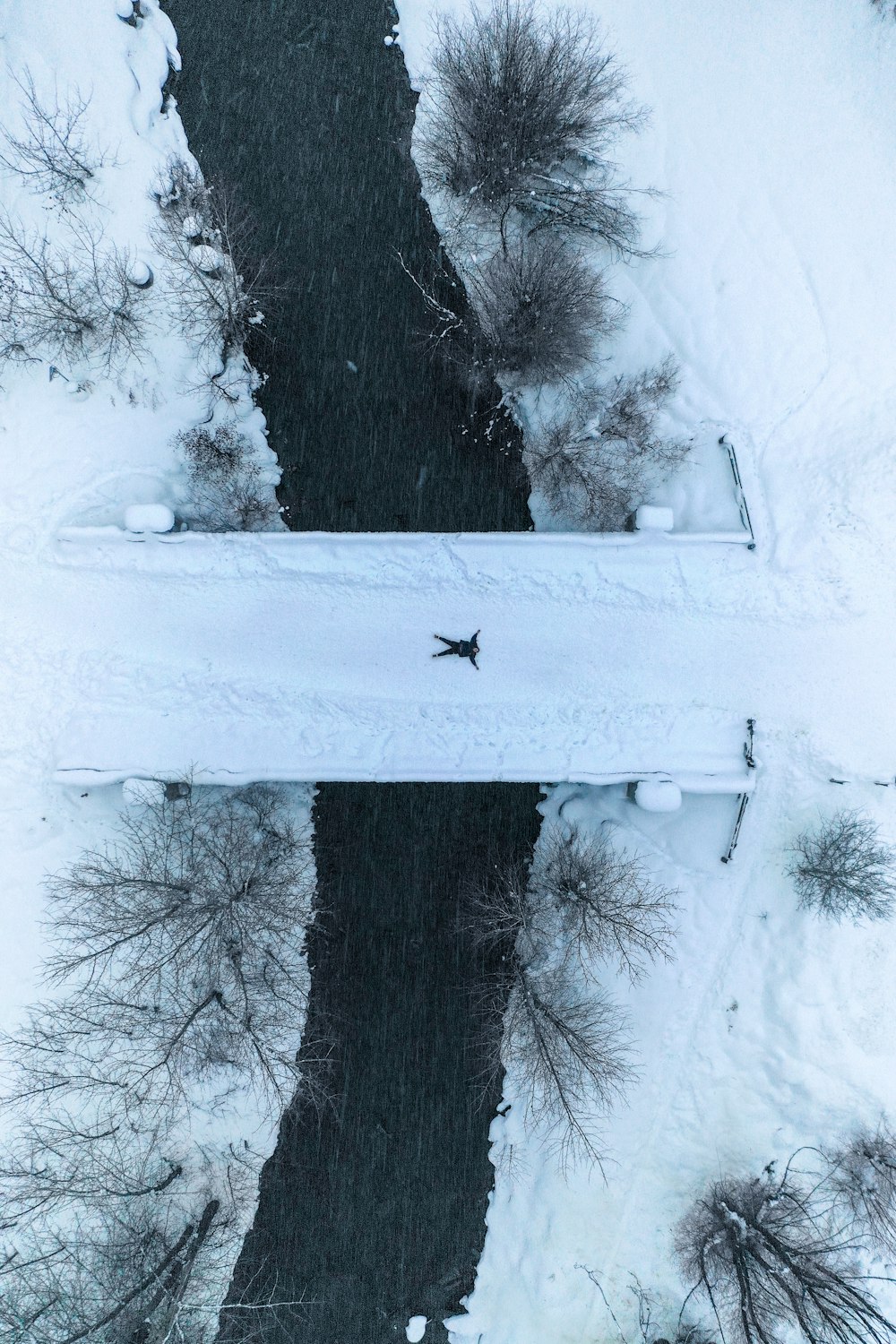 person lies on bridge