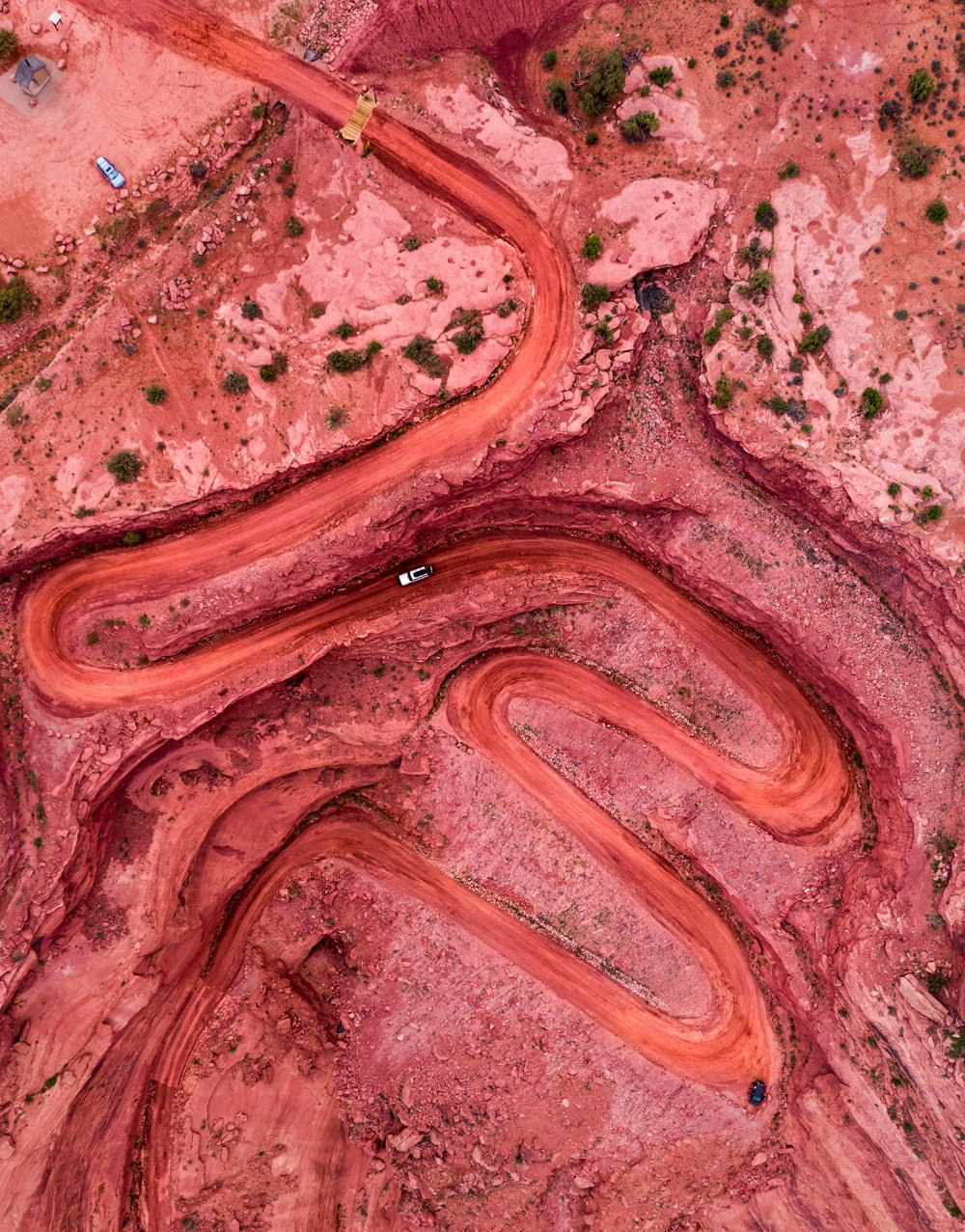 an aerial view of a winding road in the desert