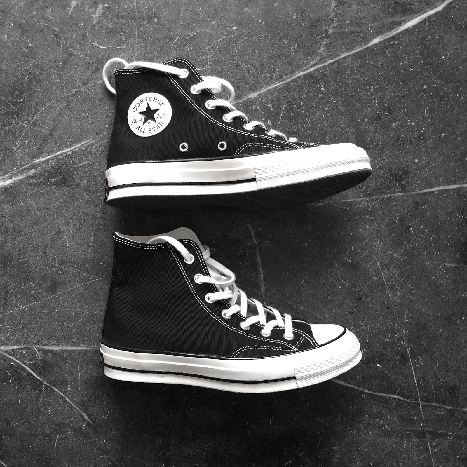 Black Converse All Star high tops on marble