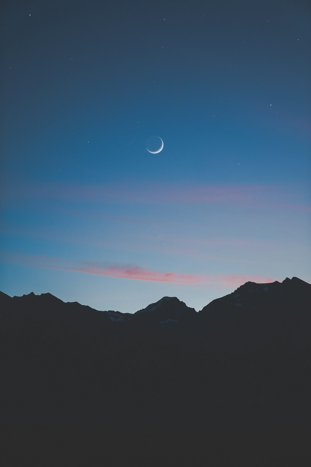 silhouette photography of mountain under clear blue sky