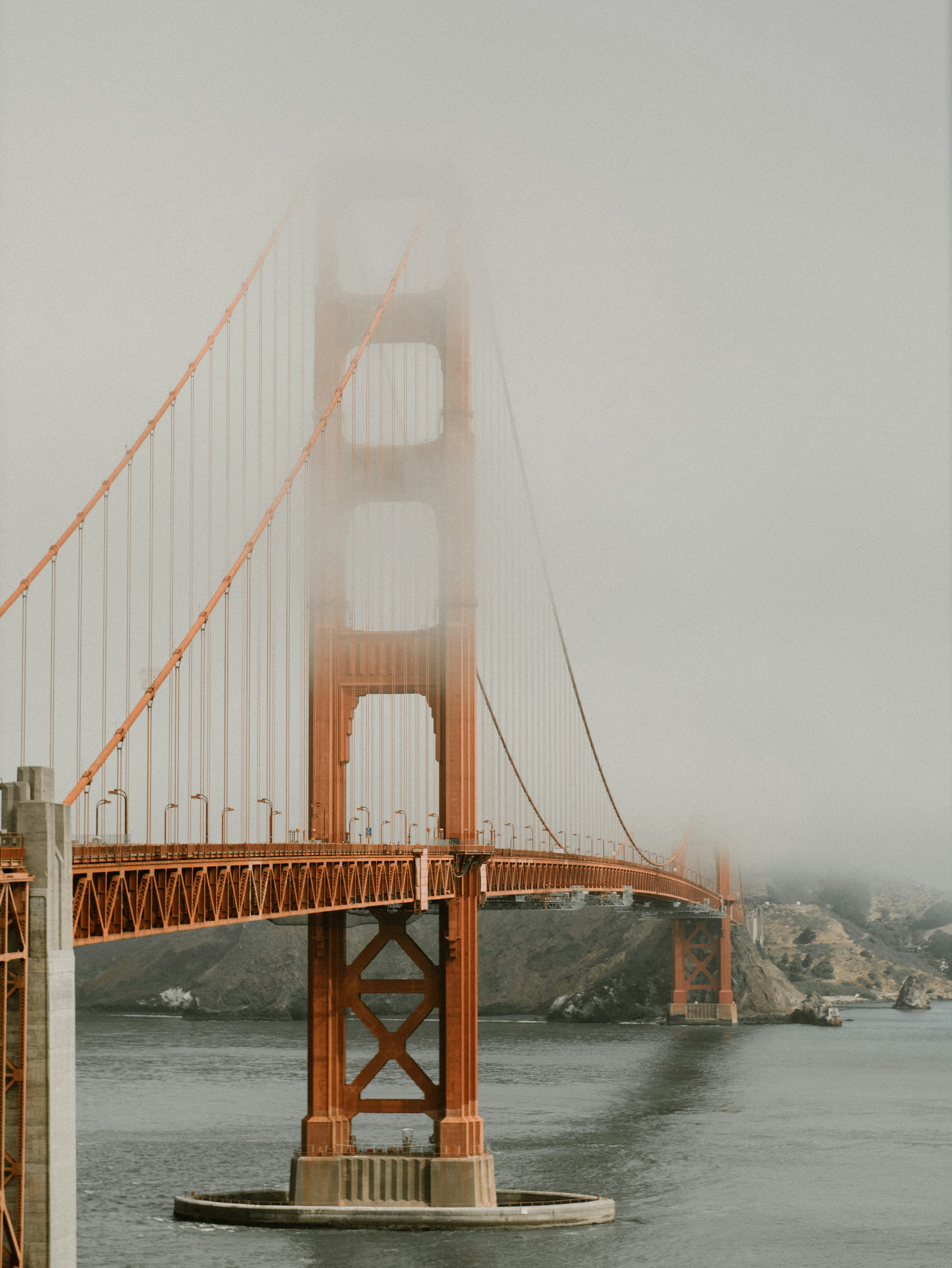 Tower of the Golden Gate Bridge disappearing in the fog, San Francisco