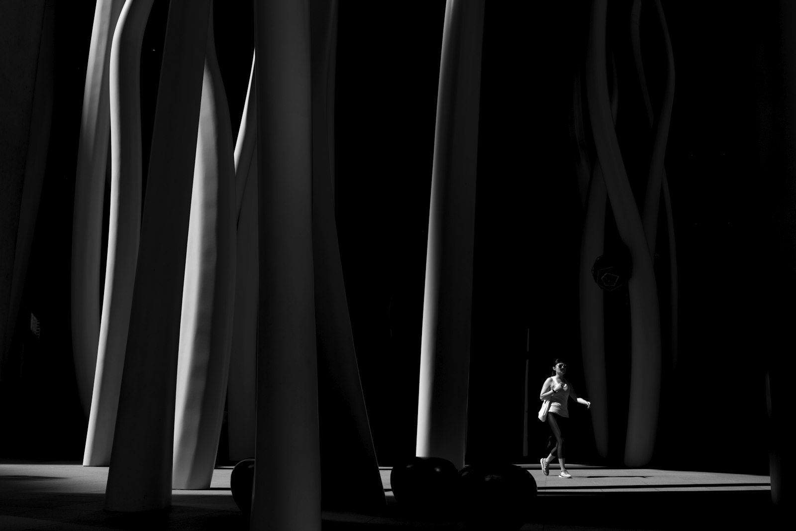 Canon EOS 7D + Canon EF-S 24mm F2.8 STM sample photo. Woman walking under structures photography