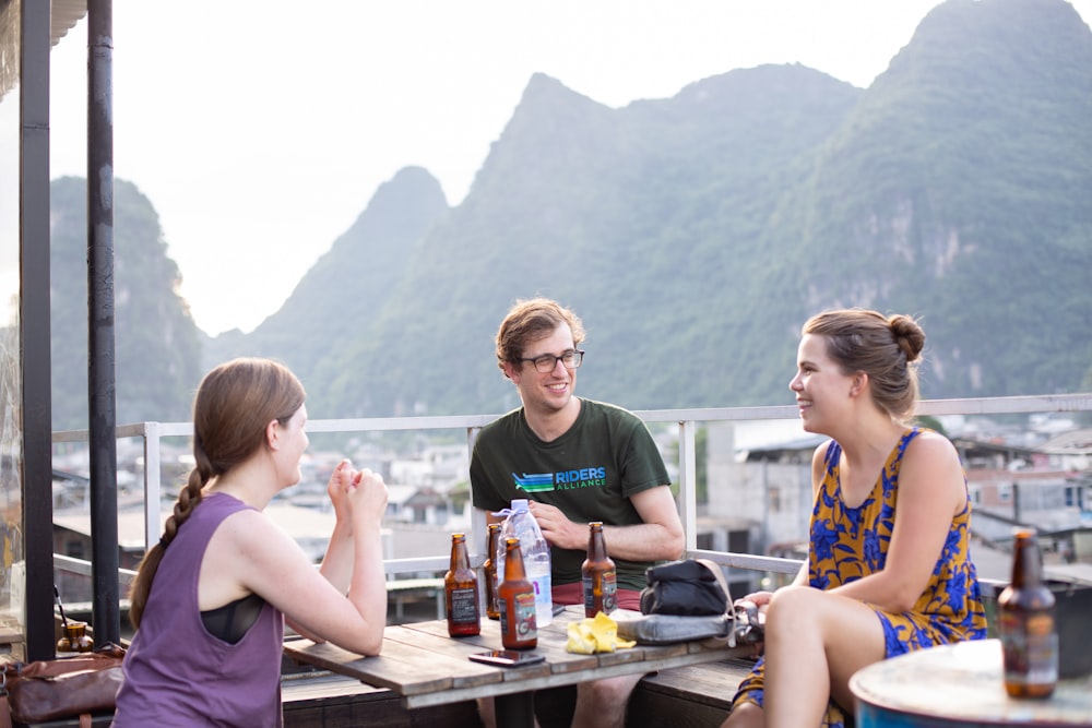 smiling man and woman sitting beside table