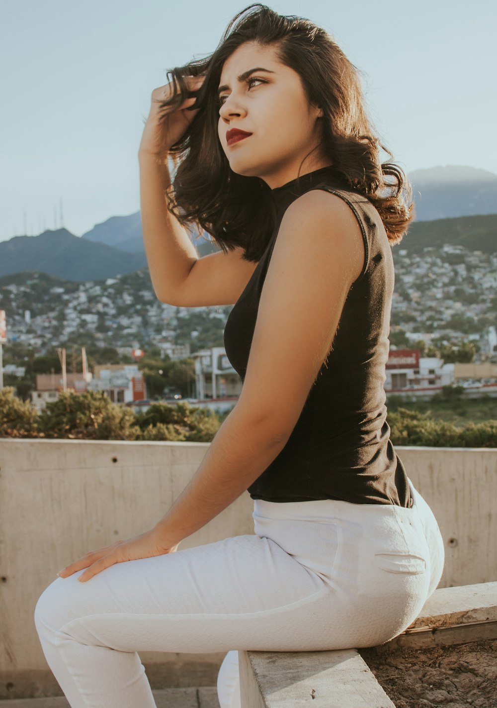 woman sitting on concrete