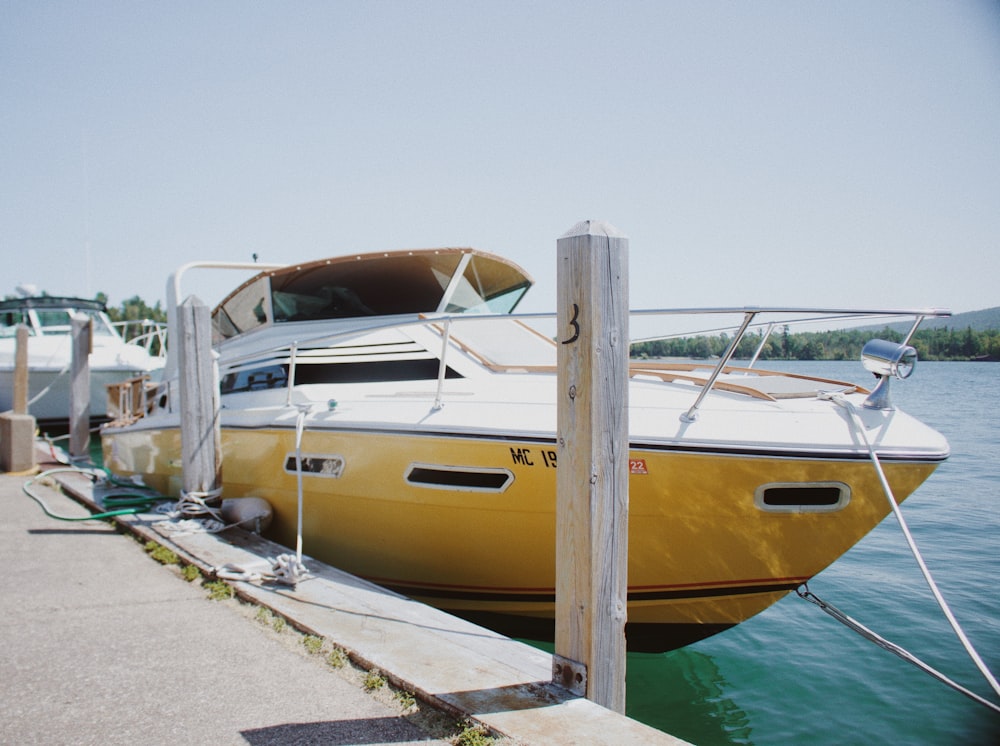 yellow and white yacht on body of water