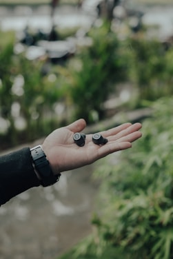 A dynamic athlete running outdoors with wireless earbuds.
