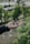 A satisfied user showcasing their neckband in a park.