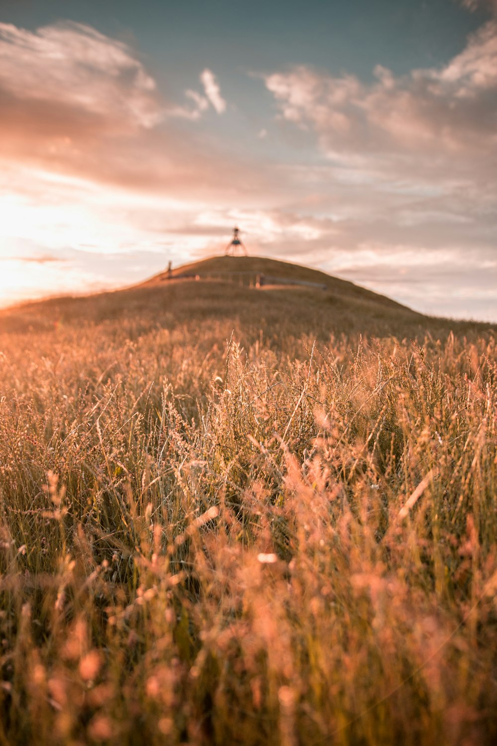 brown mountain under white sky at golden hour