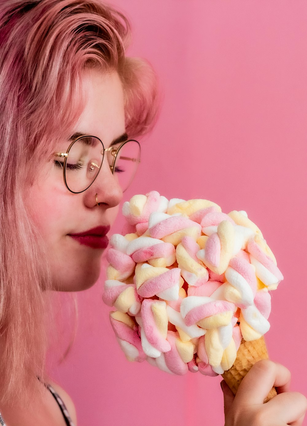 person holding cone with marshmallows