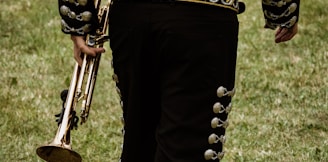 close-up photography of person holding trombone