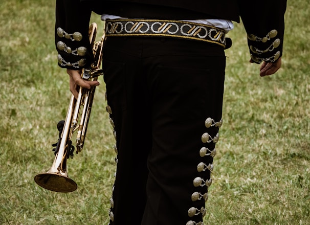 close-up photography of person holding trombone