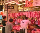 man and woman vending raw meats
