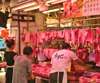 man and woman vending raw meats