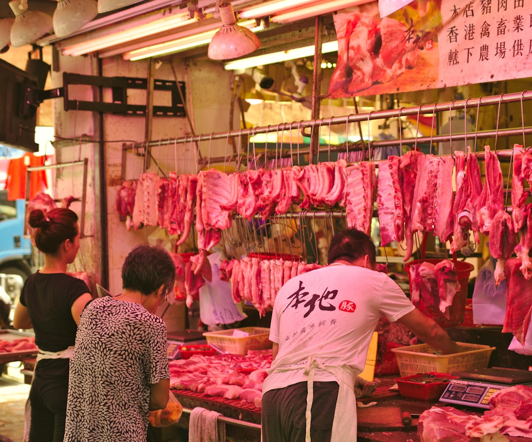 man and woman vending raw meats