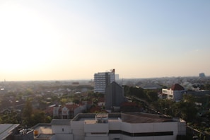 A panoramic view of a commercial complex at sunset highlighting blue and silver tones.