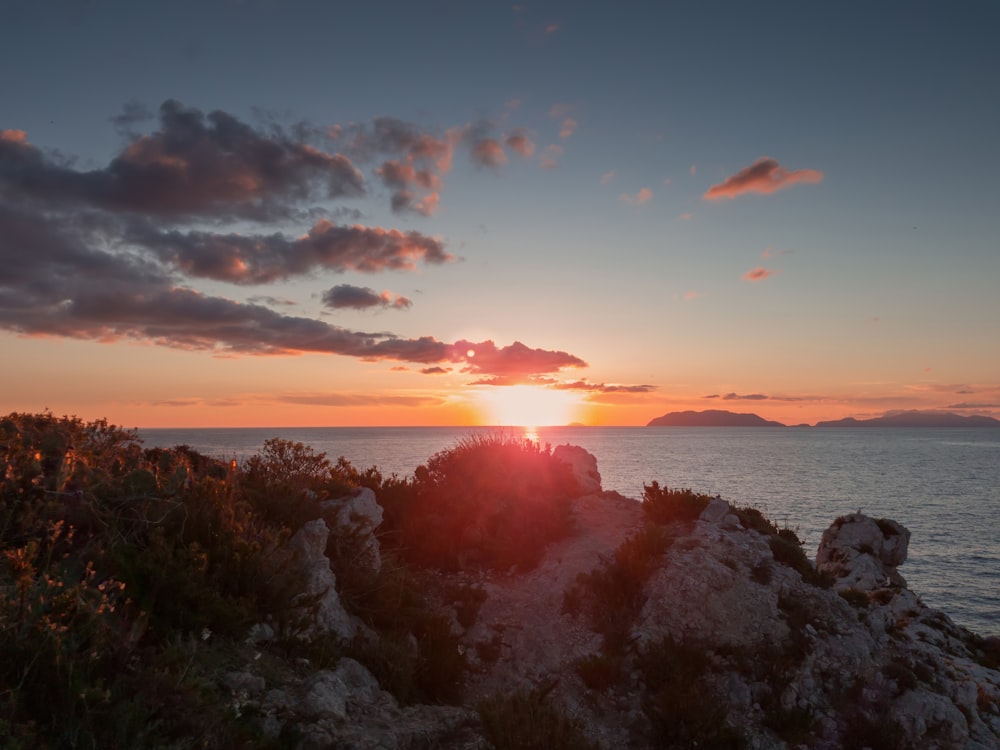 silhouette photography of mountain near ocean