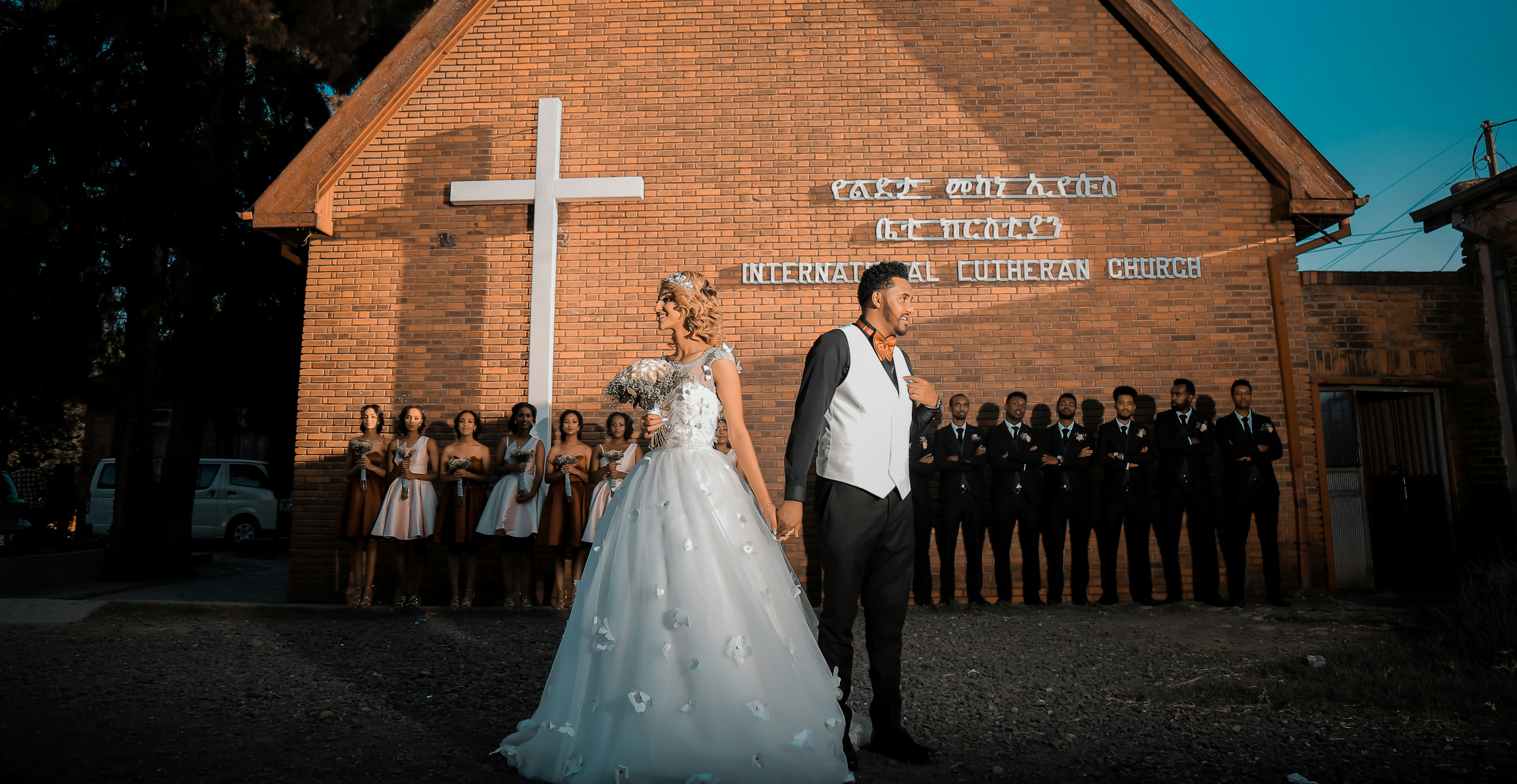 woman and man holding hands while looking opposite from each other