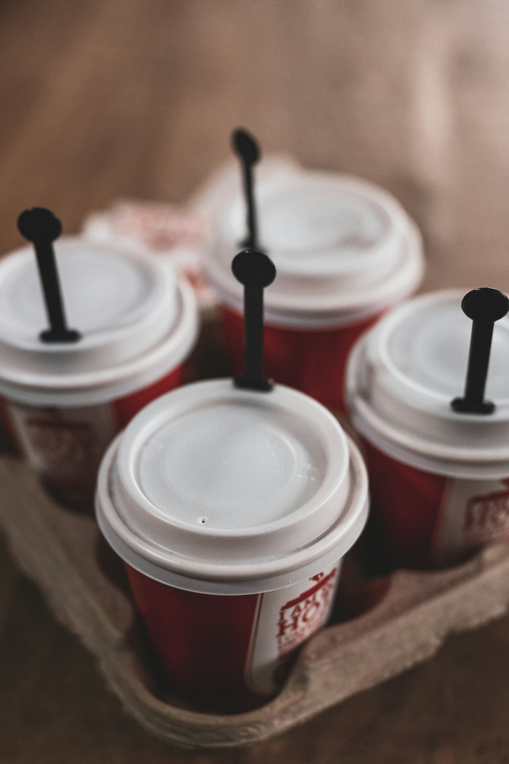 four white disposable cups