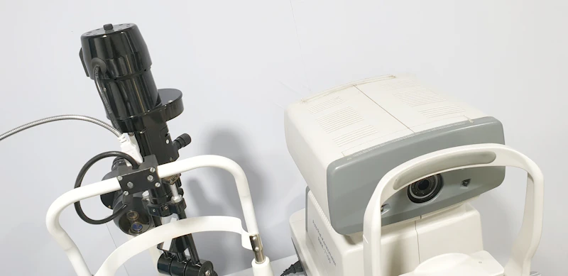 Optometrist performing retinal exam on patient