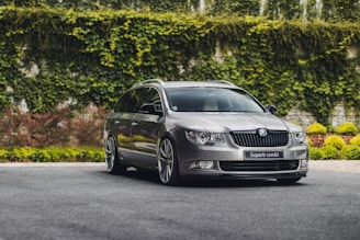 A spacious green mid-size car ready for a family trip.
