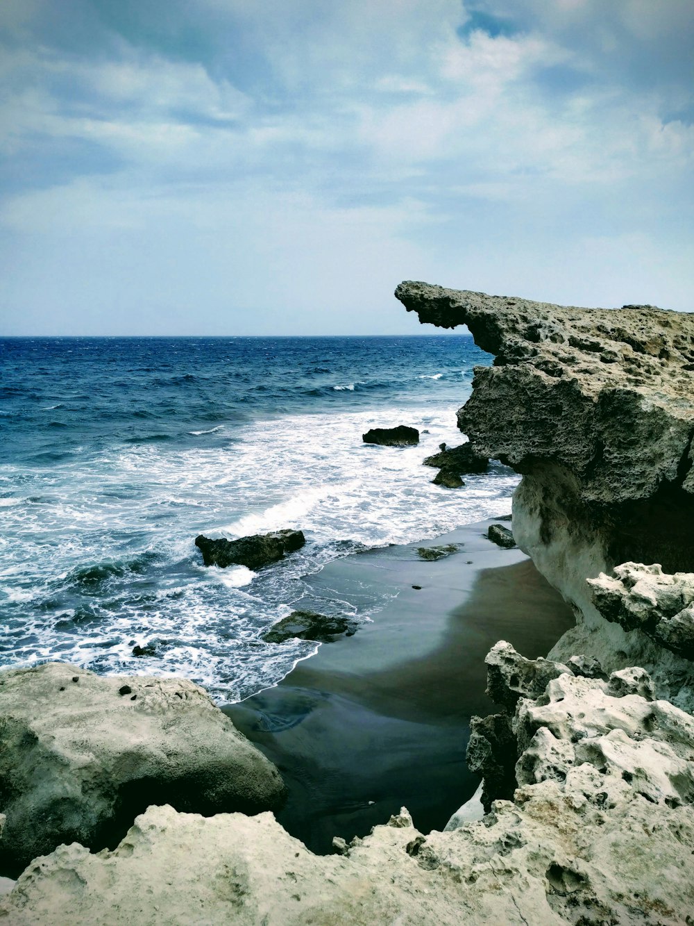 gray large stone on seashore