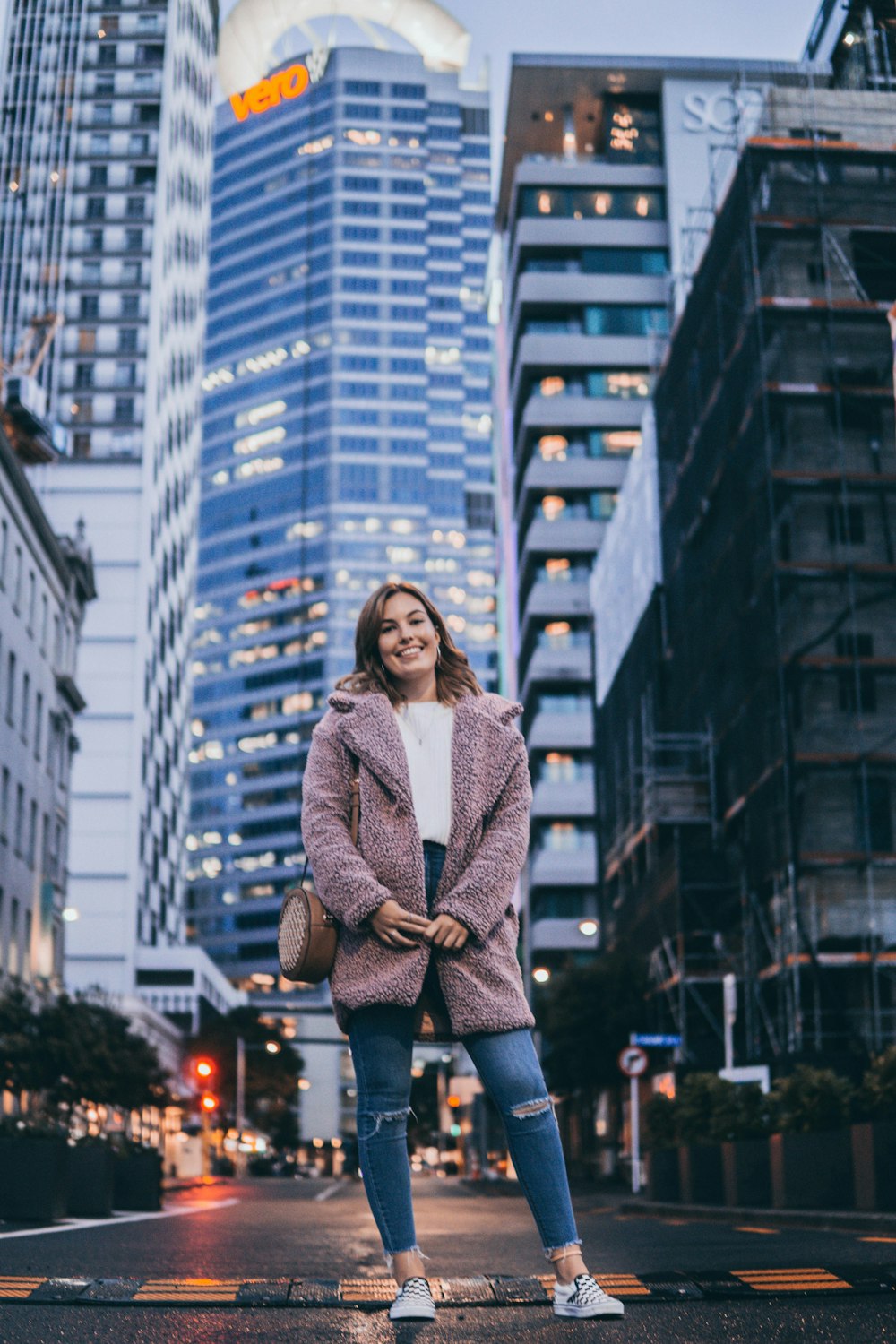 woman in jacket standing on road
