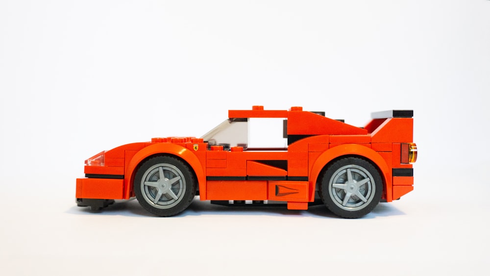giocattolo di plastica per auto arancione e nero