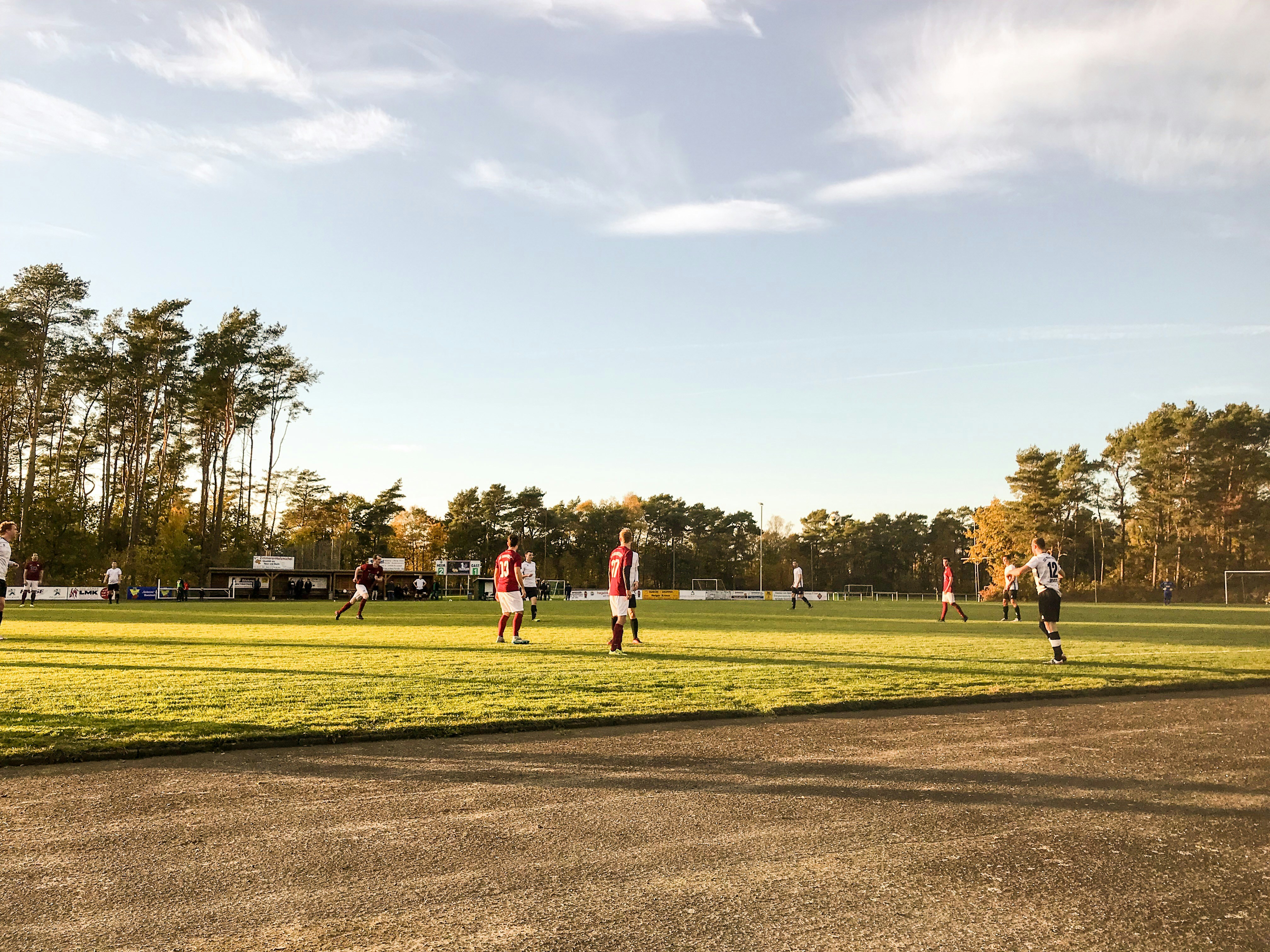 People playing soccer on a field during daytime