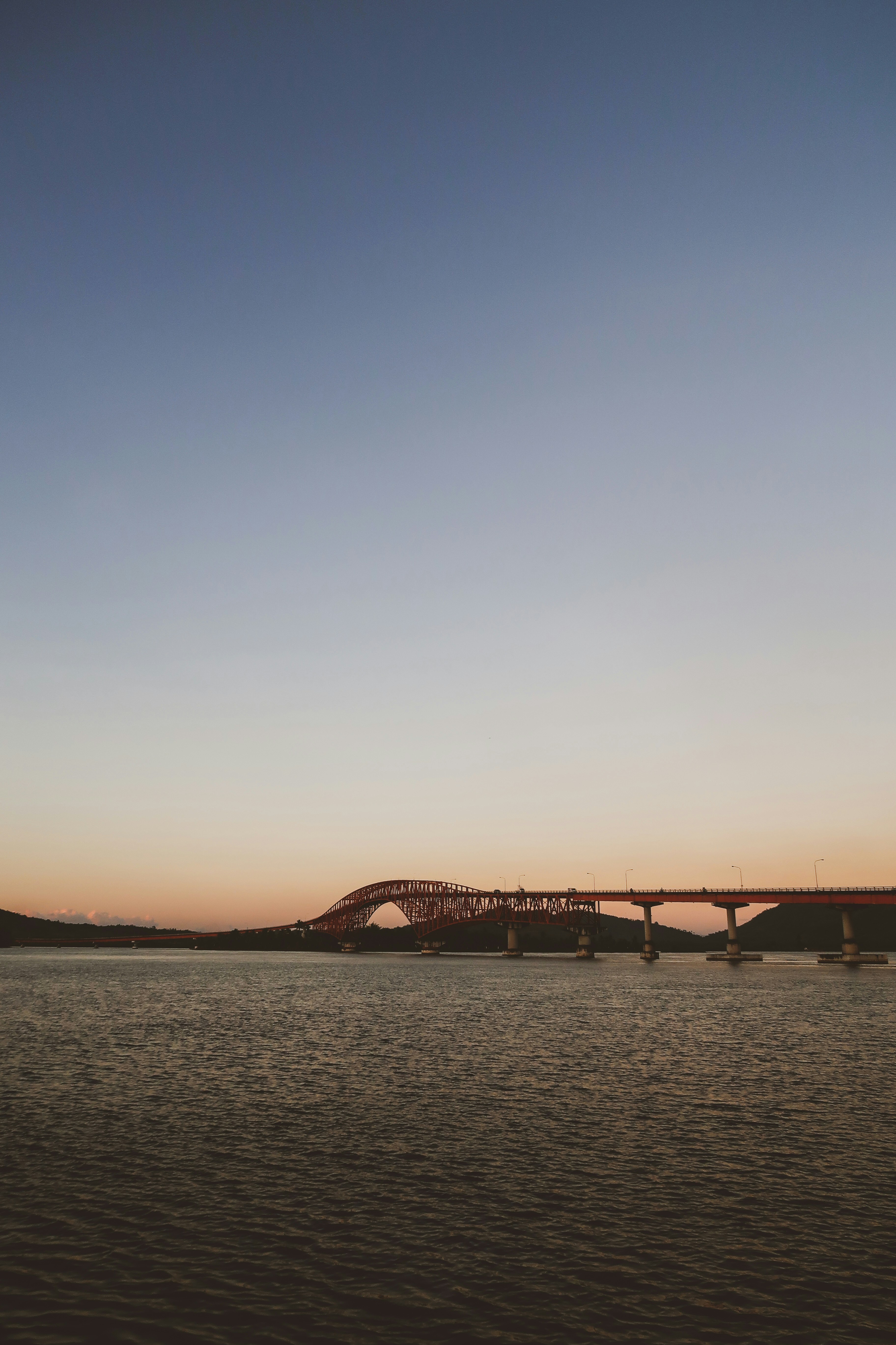 brown bridge under blue sky