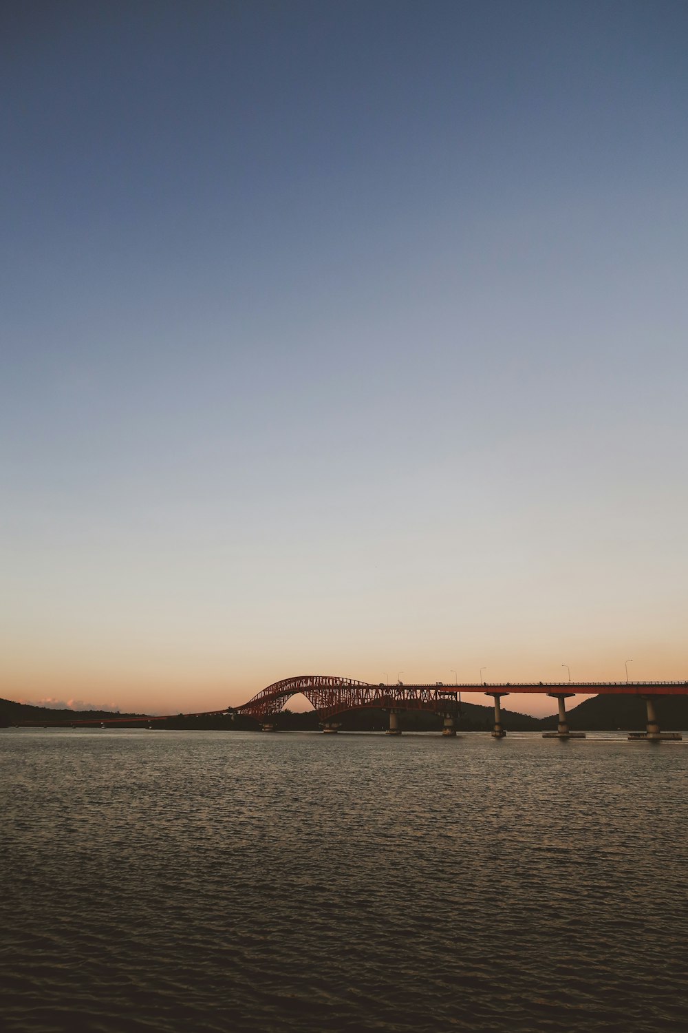 brown bridge under blue sky