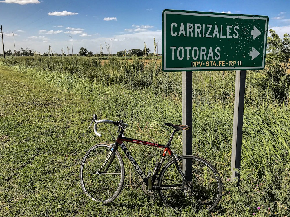 red and black Colner bike beside signage during daytime