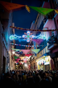 A vibrant street festival in Penang with colorful decorations and joyful crowds celebrating together.