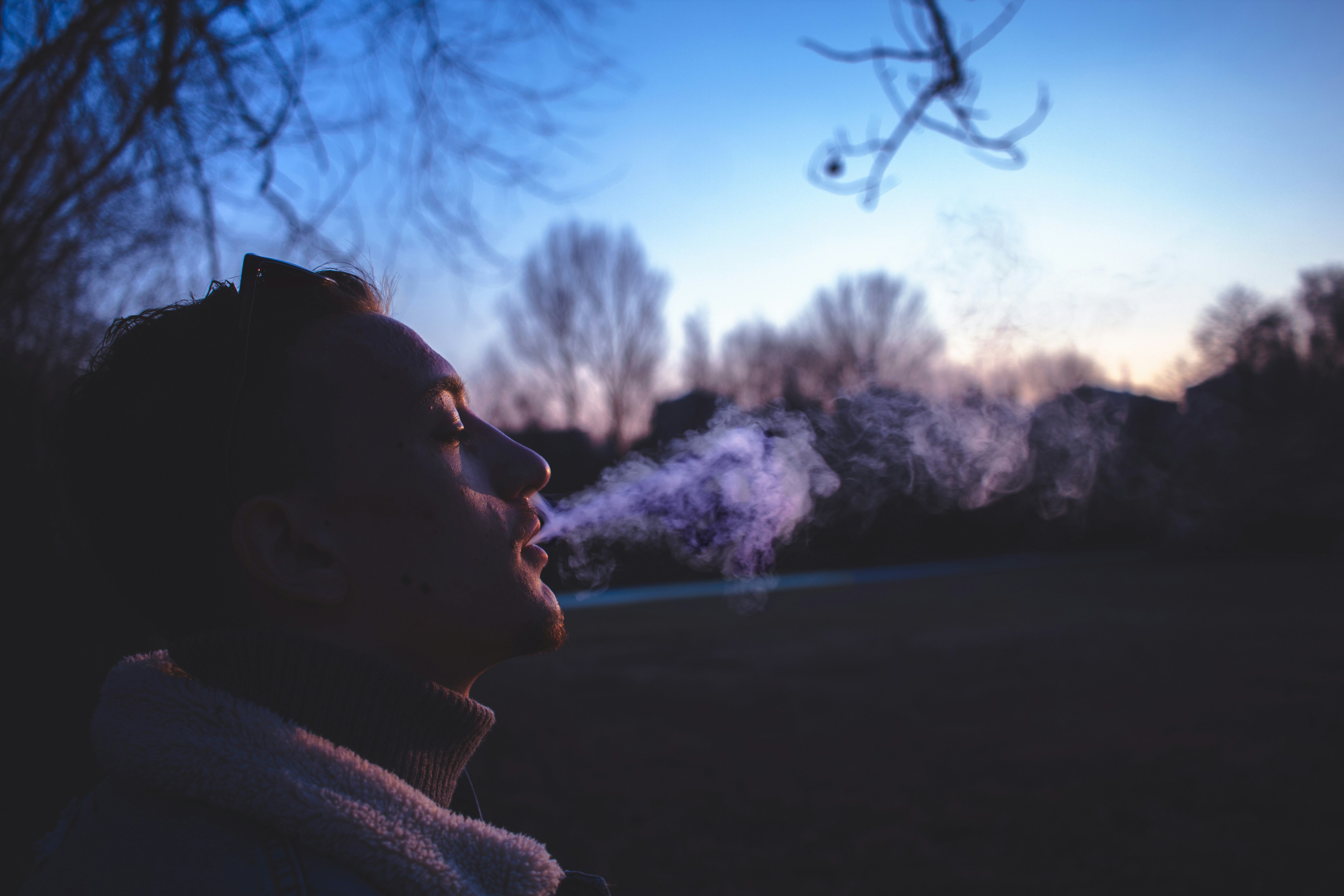 man smoking during golden hour