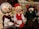 A group of intricately designed marionette puppets with cheerful facial expressions. The puppets feature vibrant costumes, with one dressed in a red outfit, another in a green suit with a hat, and a third with grey hair and a traditional vest. They are set in a theatrical backdrop, suggesting a performance or storytelling scenario.