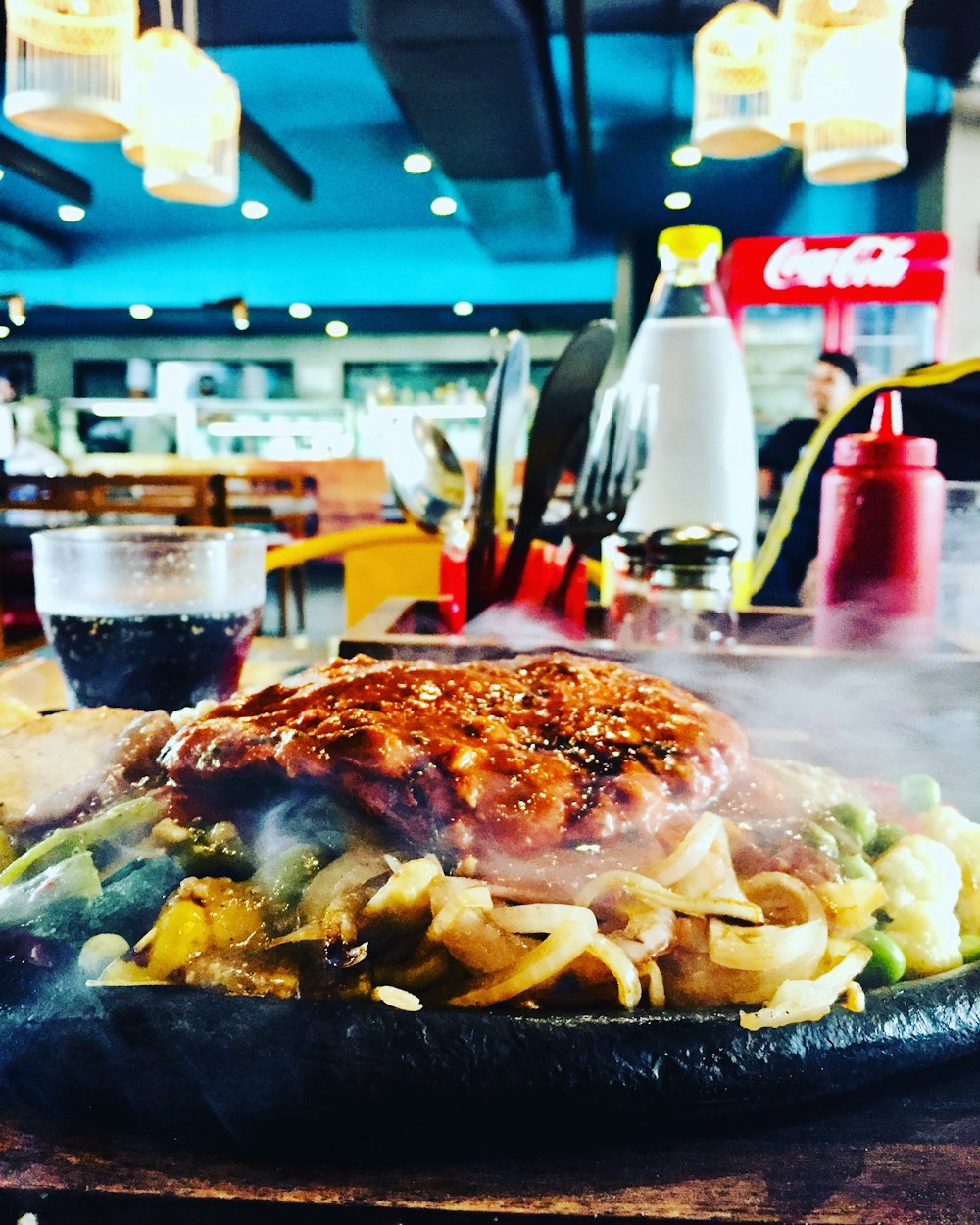 pasta with meat on black plate