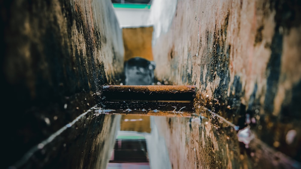 a small puddle of water in a narrow alley