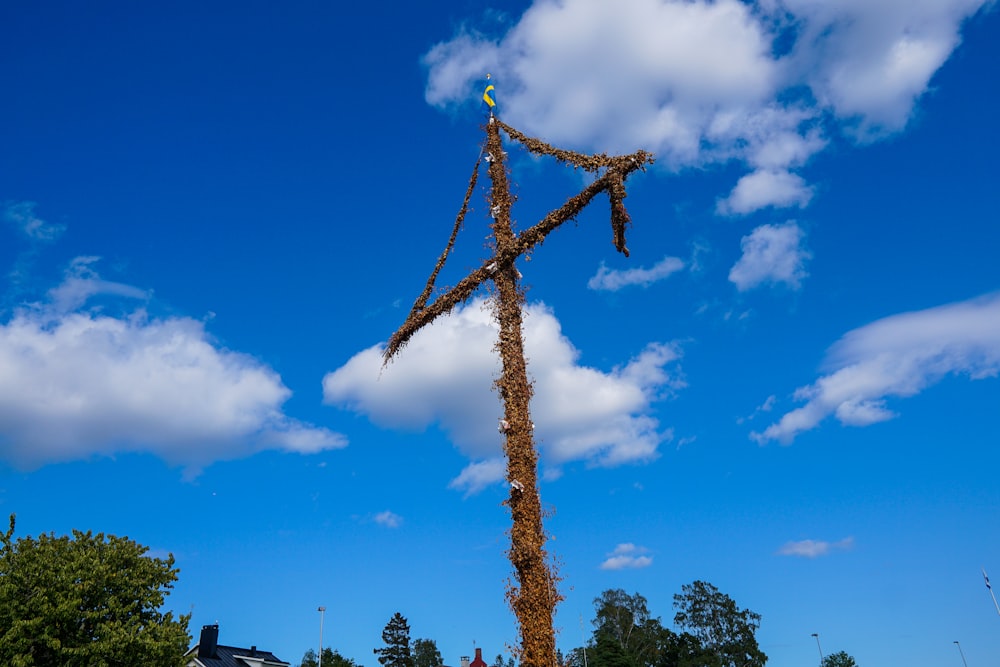 a tall pole with a bird sitting on top of it