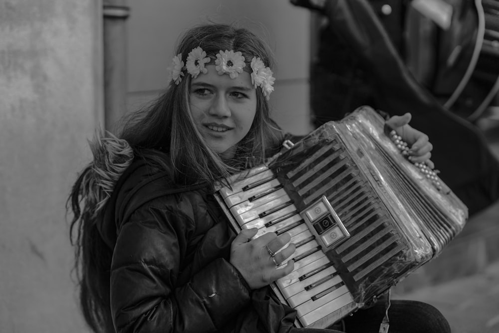 grayscale photo of a woman playing an accordion