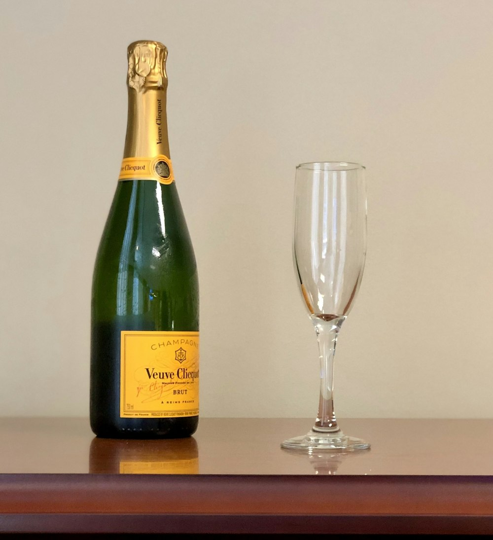 wine bottle and flute glass on table