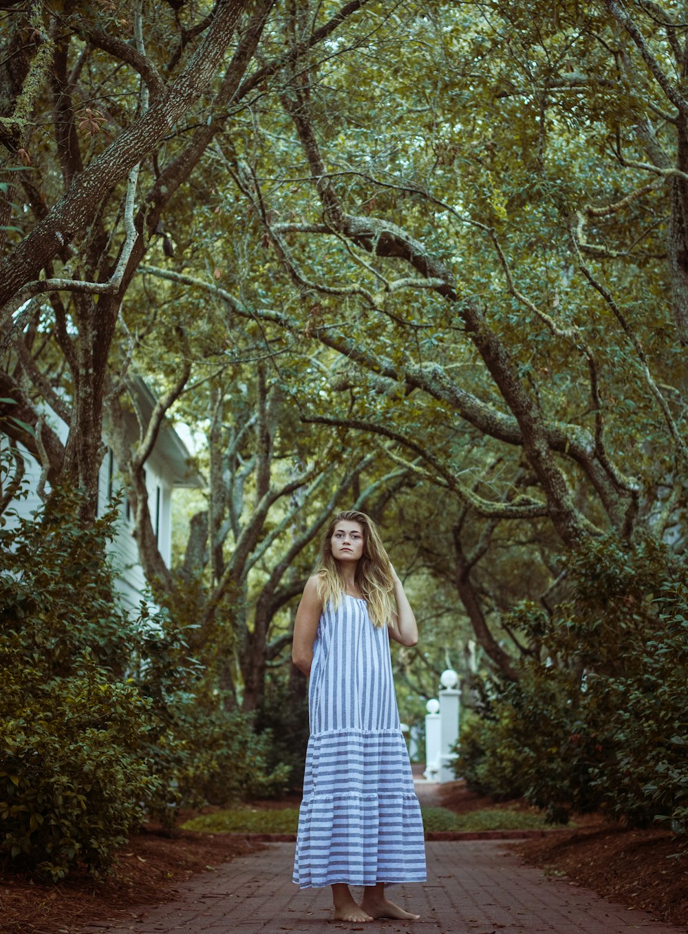 woman standing under trees