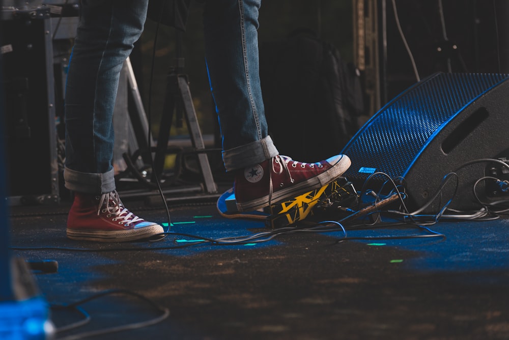 a person standing on top of a stage next to a microphone