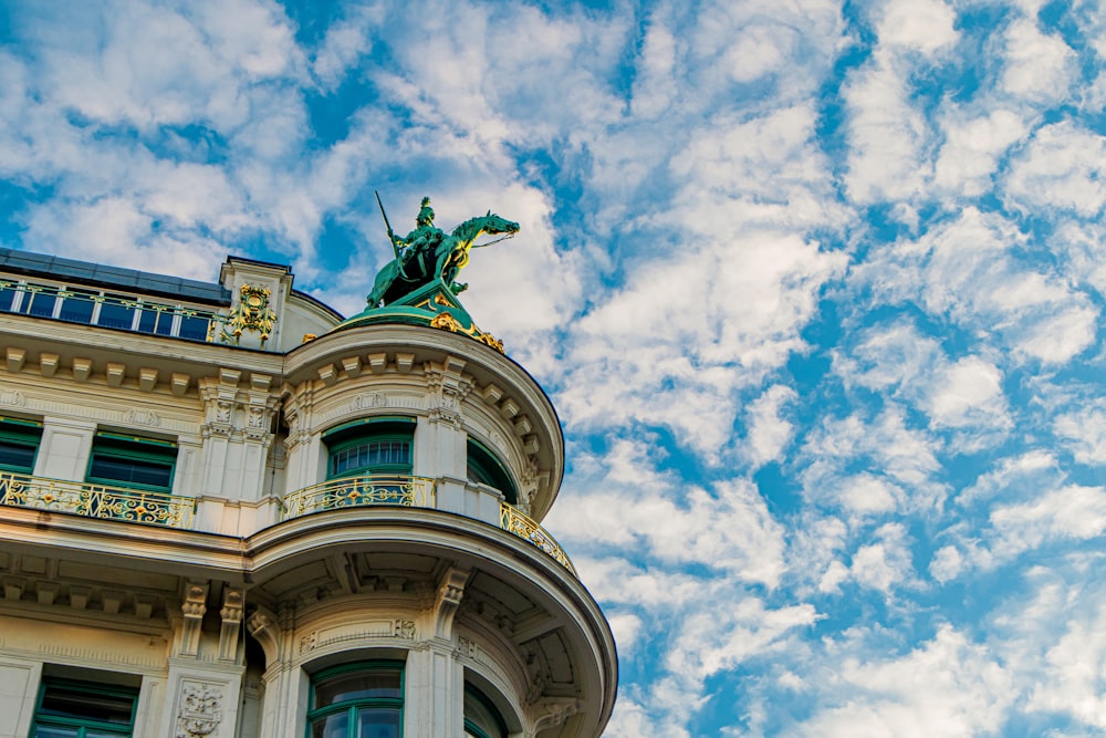 a tall building with a statue on top of it