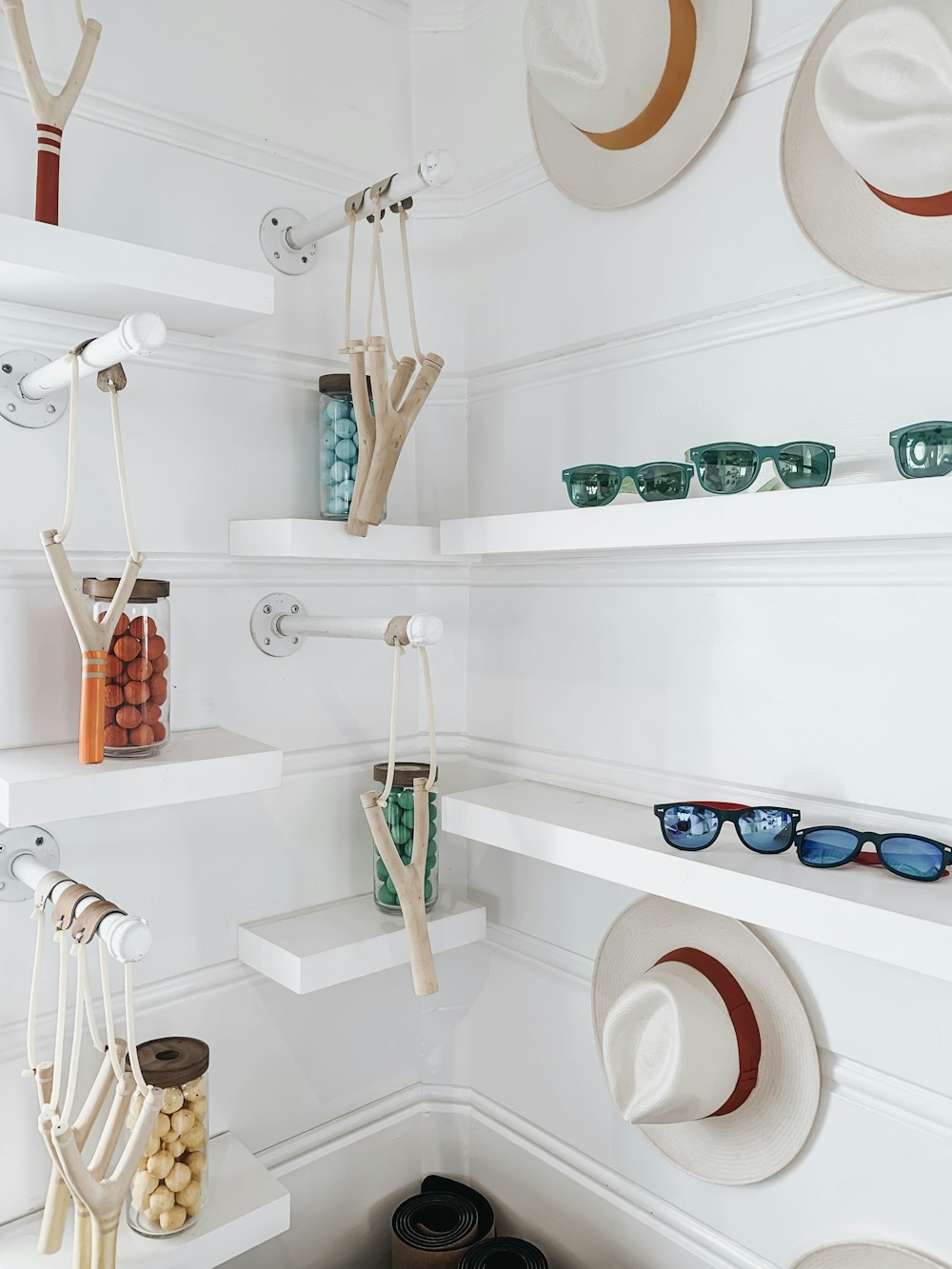 assorted-color sunglasses, bottles and straw hats