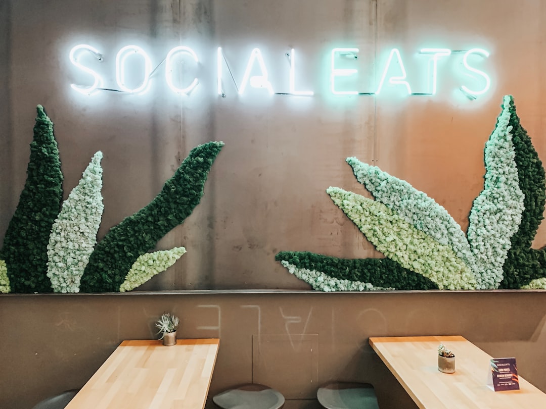 white and green Socialeats neon light sign turned on