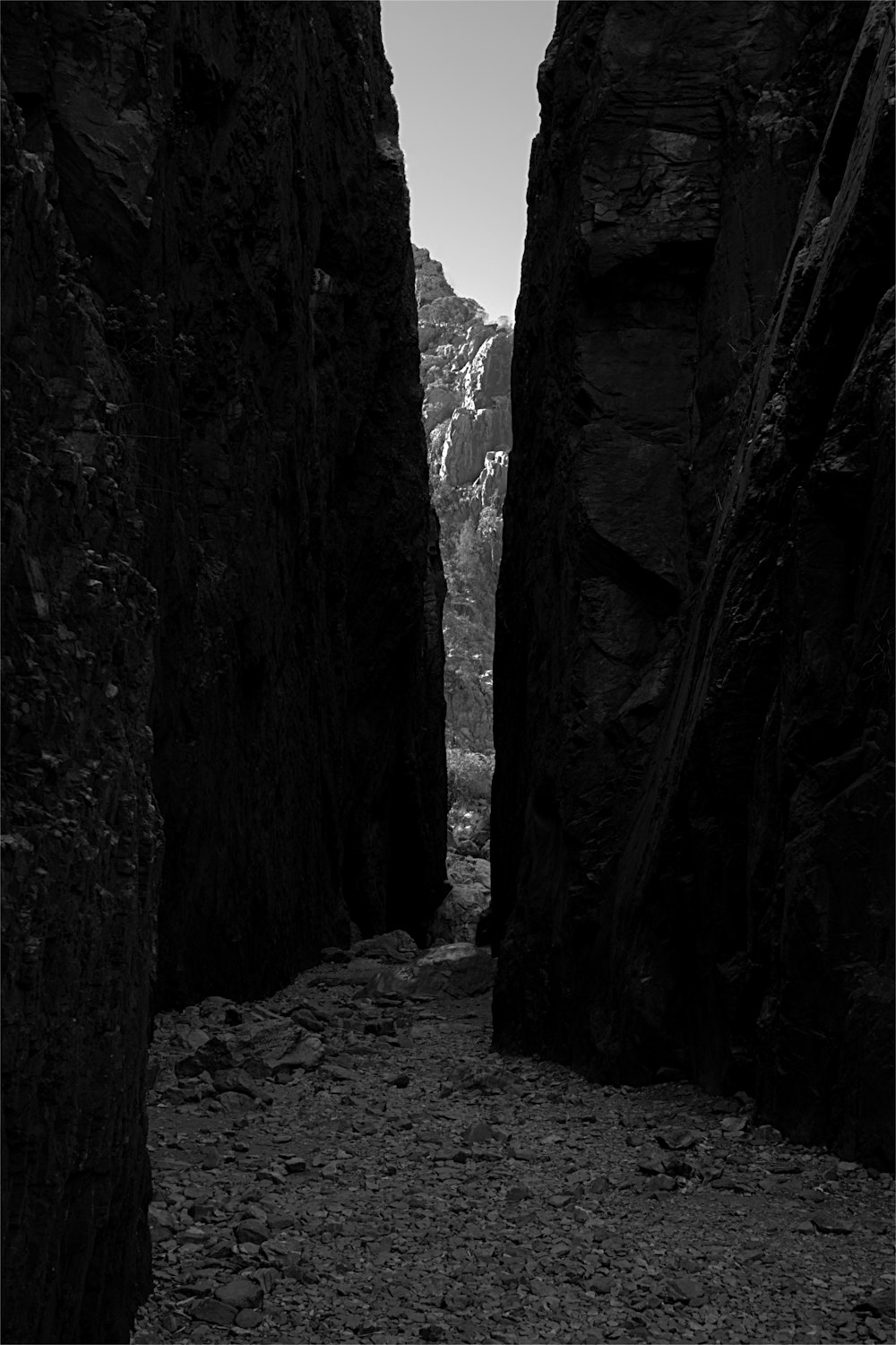 a black and white photo of a narrow canyon