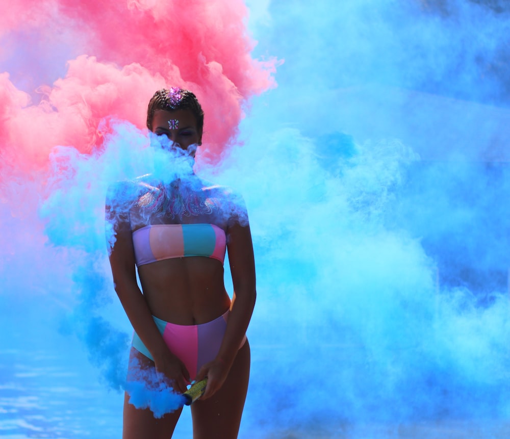 woman standing near blue smoke