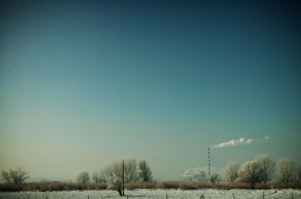 a snowy field with a power line in the distance