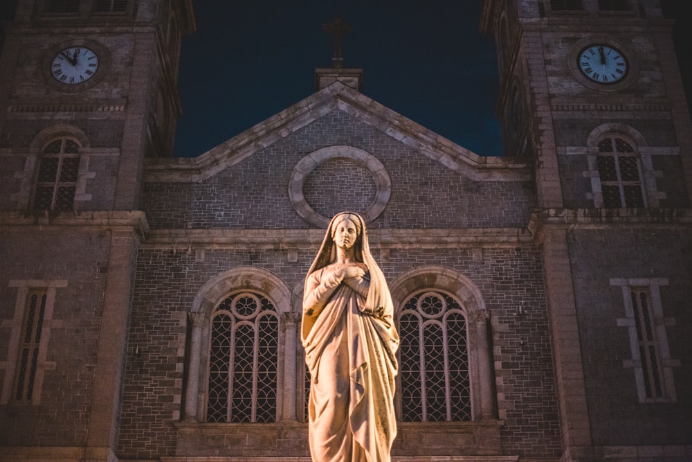 brass-colored woman statue